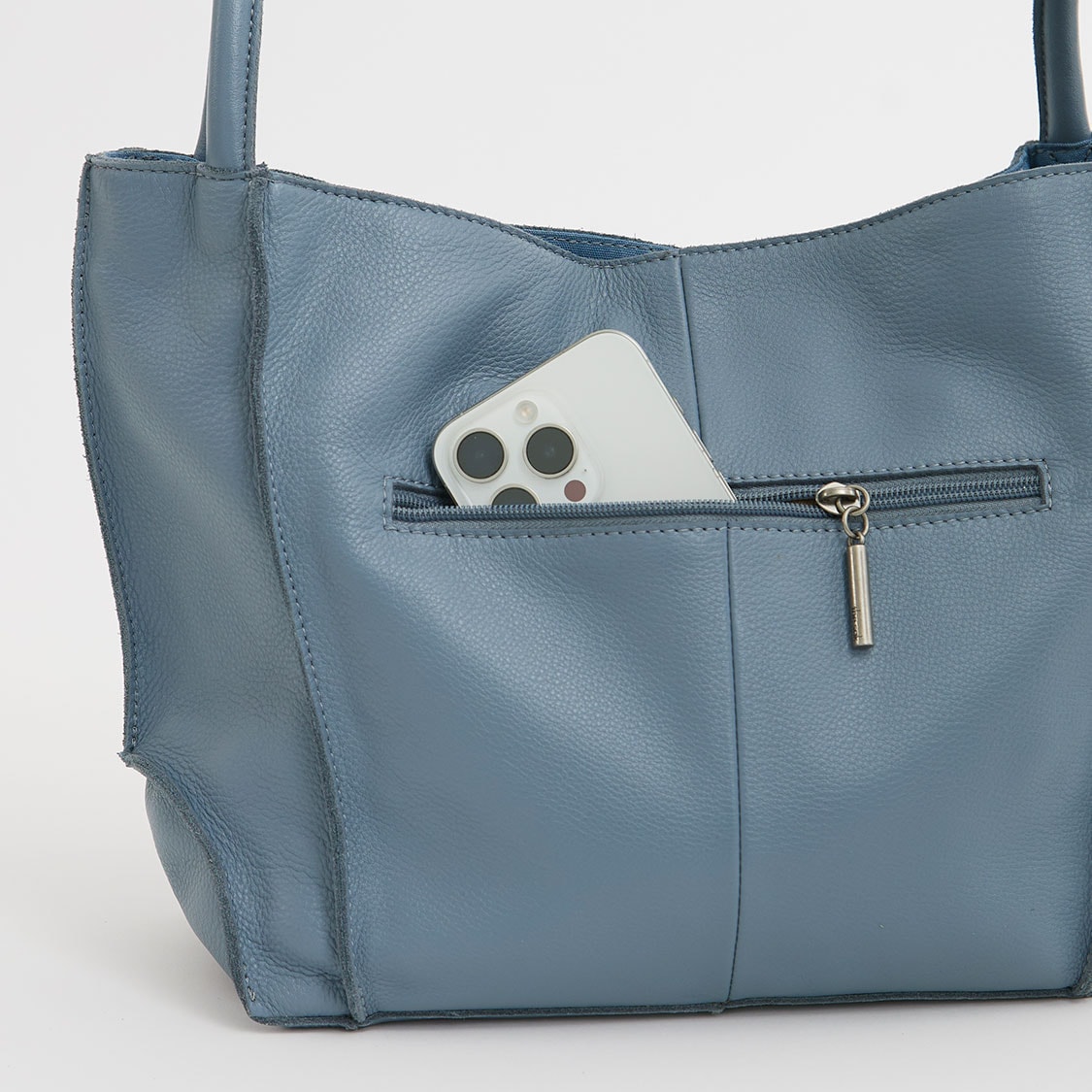 Blue tote bag with a front zip pocket holding a white smartphone